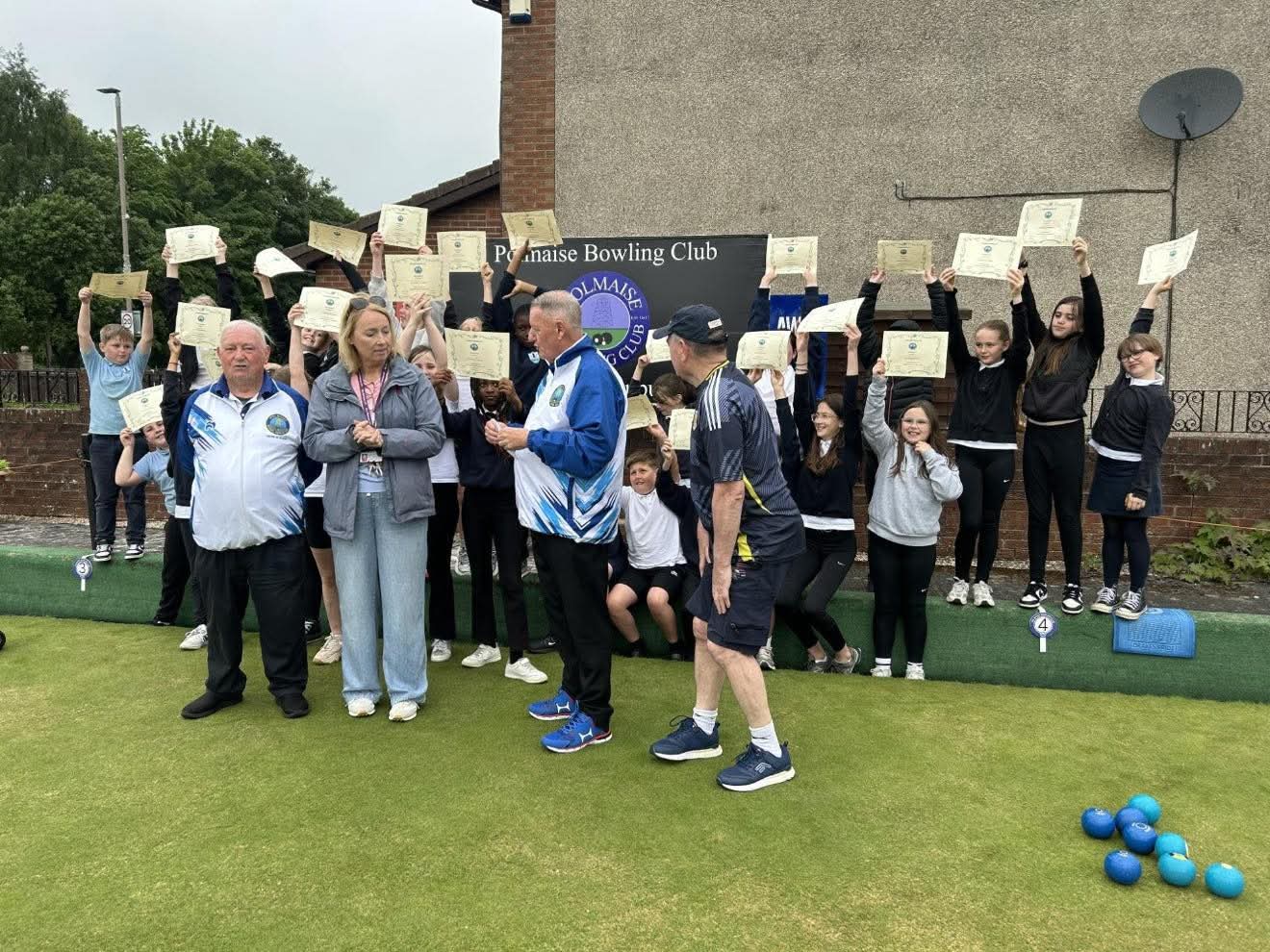 Club Secretary Peter Black and President David Stewart hand Fallin Primary School Head Teacher Mrs Brennan a £425 donation from Polmaise Bowling Club